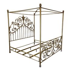 a gold metal bed frame with intricate designs on the headboard and foot board, against a white background