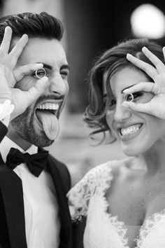 a bride and groom are making funny faces with their hands as they pose for the camera