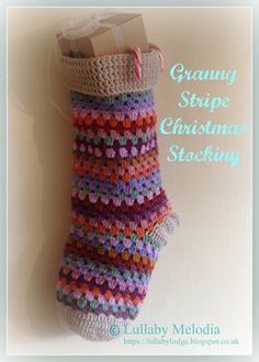 a crocheted christmas stocking hanging on a wall with the text granny stripe christmas stockings