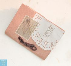 an old pink book with lace and scissors