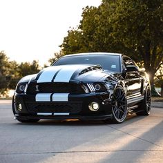 a black and white mustang parked on the street