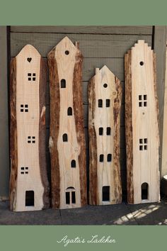 three wooden buildings are lined up against the wall