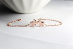 "This bunny or rabbit in rose gold bracelet is truly one of a kind and a must have for every couple! Sold as a pair animal,. A meaningful, sweet love gift every couple should have it. It's also a beautiful piece for perfect mother daughter gift, gift for sisters, birthday present for her, for friends and niece gift. * 14k Rose Gold filled chain and clasp * Glossy 18k Rose Gold Plated bunny Metal Bead, measures 17 x 12mm * Pink sweet tiny heart bead:8x8 mm HOW TO ORDER: In the \"note to seller\" Rabbit Bracelet, Bunny Bracelet, Jewelry Couple, Bunny Jewelry, Rabbit Jewelry, Birthday Presents For Her, Niece Gifts, Gold Animals, Mother Daughter Gifts