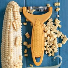 corn on the cob is being cut with a vegetable slicer and other tools