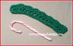 green crocheted candy cane holder with white and red striped candy