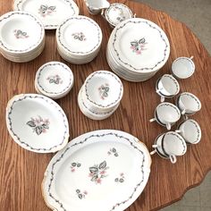 a wooden table topped with lots of white dishes