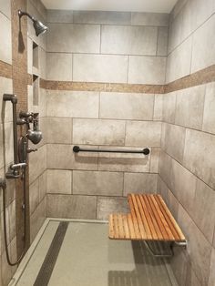 a wooden bench sitting inside of a shower