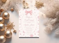 a pink and white christmas party card with snowflakes, ornaments and gold balls