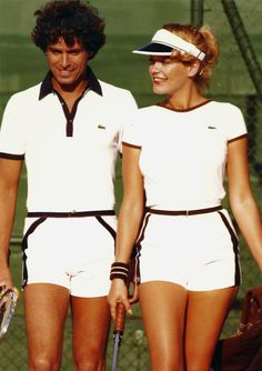 two tennis players standing next to each other holding racquets