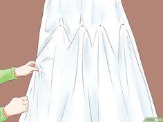 a person is holding the back of a white dress