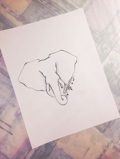 an elephant's head is drawn on paper