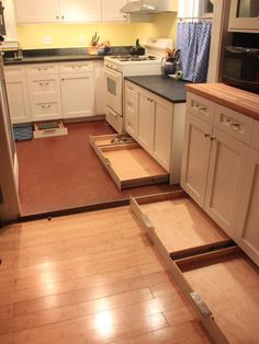 an image of a kitchen being remodeled with wood flooring and new cabinets in place