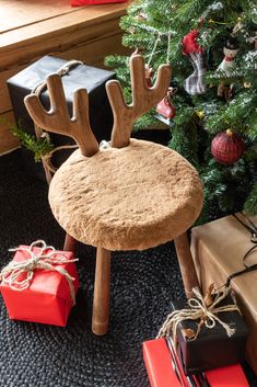 a chair with reindeer antlers on it next to presents