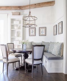 a dinning room table with chairs and a bench