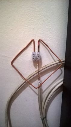 two wires connected to an outlet on the wall