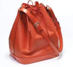 Louis Vuitton Noe Bucket Bag.Louis Vuitton Noe Epi orange leather bucket bag in very good condition, with slight wear on the surface. Collectors item! Serial number #TJ3153 Issued in 2013 Approximate Measurements: Length 10”, Height 13”, Width 7” Made in France. Louis Vuitton Epi Bucket Bag, Luxury Elegant Yellow Bucket Bag, Luxury Yellow Elegant Bucket Bag, Handcrafted Handbags, Buy Louis Vuitton, Bag Louis Vuitton, Trendy Handbags, Genuine Leather Handbag, Leather Bucket Bag