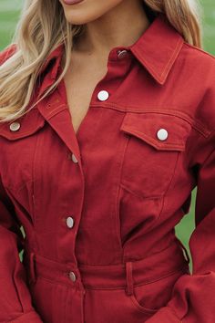 Crafted from 100% cotton, this Red Denim Romper exudes a classic & sophisticated charm, perfect for any sports event! Featuring a collared v neckline and functional buttons, this romper also boasts both chest and front/back pockets for convenience. The button zip fly closure and buttoned cuffs add a touch of elegance to this versatile piece. Simply style it with your favorite knee high boots and then add some matching accessories for an elevated chic look! Spring V-neck Denim Jumpsuit With Pockets, Spring Cotton V-neck Denim Jumpsuit, Casual Cotton Button-up Jumpsuits And Rompers, Cotton Denim Button-up Jumpsuit, Button-up Cotton Denim Jumpsuit, Spring Cotton Denim Jumpsuit, Relaxed Cotton Denim Jumpsuit With Button Closure, Collared Jumpsuits And Rompers With Pockets In Relaxed Fit, Fall Denim Jumpsuit With Long Sleeves And Buttons