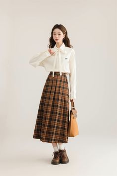 Pleated plaid midi skirt in cozy colors to go with your autumnal fits. Features an elastic waist back. Lined. One Size: 26"-36" waist, 31" length Fall Plaid Relaxed Fit Skirt, Casual Plaid Skirt For Fall, Plaid Relaxed Fit Skirt For Fall, Relaxed Plaid Skirt For Fall, Casual Plaid Skirt For Winter, Casual Plaid Winter Skirt, Plaid Pleated Skirt For Workwear In Fall, Casual Plaid Skirt For Work, Fall Plaid Long Skirt