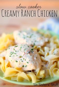 a green plate topped with pasta covered in creamy ranch chicken