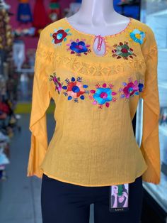 Great customer is our priority We're Friendly and Helpful Check our feedbacks We are listing a Brand New never been Used100% Authentic Mexican Dress                                This Blouse is gorgeous. 100% Authentic Mexican Shirt This Shirt is gorgeous. Color:yellow  Size:M/L Chest: 23 Waist: 23" Sholder:23" Sholder to hem:26" Ebroidery Mexican shirt Please take a good look an the picture to see if this is the color your looking for. Folk Fabric Flowers Mexican Tunic Traditional Embroidery T Yellow Long Sleeve Tops With Floral Embroidery, Yellow Embroidered Cotton Shirt, Summer Yellow Embroidered Shirt, Casual Yellow Long Sleeve Peasant Top, Bohemian Yellow Tops With Floral Embroidery, Yellow Bohemian Tops With Floral Embroidery, Embroidered Yellow Summer Blouse, Yellow Long Sleeve Blouse With Floral Embroidery, Yellow Embroidered Summer Blouse