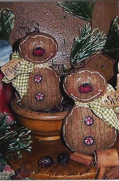 three gingerbreads sitting on top of a table next to a potted plant