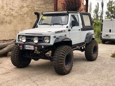 an off - road vehicle parked in front of a building