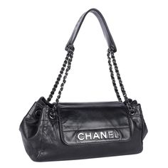 Authentic, pre-loved vintage Chanel black classic CC front flap shoulder bag. Black was Coco's happiest color and it's displayed in every Chanel collection. Features lambskin black leather, this Chanel shoulder bag has a CC silver logo zipper pull, front flap magnetic snap closure, large interior with 1 zipper pocket, silver hardware with cinch straps, and shoulder guard. Strap drop: 11" with shoulder guards Authenticity hologram sticker read: 10509358 Made in Italy 2005-2006 Messy Model, Shoulder Guard, Chanel Collection, Flap Shoulder Bag, Chanel Shoulder Bag, Vintage Purses, Formal Shoes For Men, Silver Logo, Shoulder Bag Black