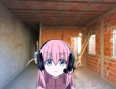 an anime character with headphones and pink hair wearing ear muffs in a hallway