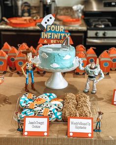 a table topped with cake and toy figurines