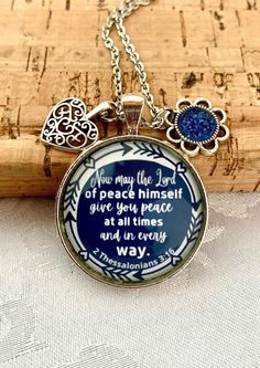 "Scripture Necklace, Christian jewelry for women, Gift for women, Bible Verse Necklace, faith jewellery This beautiful necklace have a blue background and it comes with 2 charms as in the picture. quote reads: \" Now may the Lord of peace himself give you peace at all times and in every way.\" 2 Thessalonians 3: 16   Pendant is silver colour, 30 mm in size.  the chains are: - 24 inches long, cable chain stainless steel - 30 inches long, ball chain stainless steel please do not swim or shower wit 2 Thessalonians 3 16, Christian Jewelry For Women, Verse Necklace, Bible Verse Necklace, 2 Thessalonians, Necklace Christian, Picture Quote, Bless The Lord, Faith Jewelry