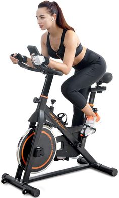 a woman riding an exercise bike on a white background