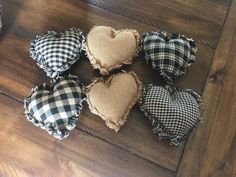 four heart shaped cushions sitting on top of a wooden floor