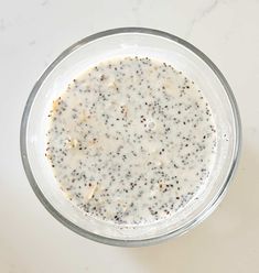 a glass bowl filled with white liquid on top of a table