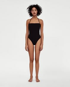 a woman in a black one piece swimsuit