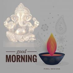 an elephant statue sitting on top of a table next to a candle with the words good morning