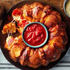 a plate with some food on it and sauce in the middle next to other dishes