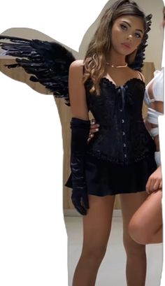 a woman in a black corset and angel wings