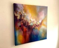 an abstract painting hangs on the wall