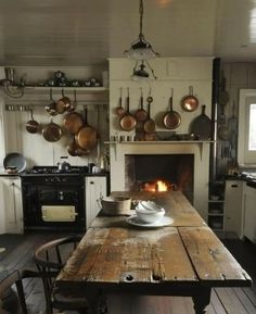 a kitchen with an oven, stove and table in it