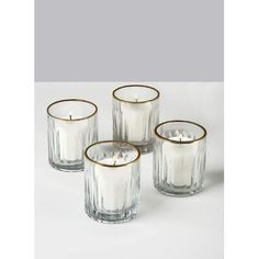 three clear glass candles with gold rims