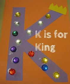 the letter k is for king made out of construction paper and plastic beads on an orange background