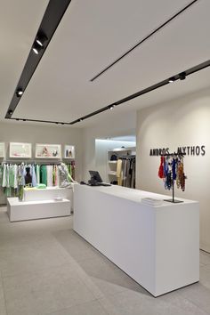 the inside of a clothing store with clothes on display