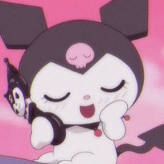 a cartoon character holding a black and white cat with its eyes closed while sitting on top of a table