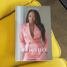 a book titled the book title is displayed on a yellow chair