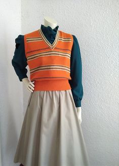 Materials: vintage woman orange vest 70s retro vest, striped vivid color vest, orange spring vest, V-neck mod vest, preppy knitted vest, summer vest, high waist vest, acryl vest. The vest is not dry clean. Measurements laying flat : shoulders :37 cm (14,5 inches) bust:49 cm (19,5 inches) total lenght:54 cm (21 inches) Waist Vest, Retro Vest, 60s Women, Woman Vest, Summer Vest, Fashion Forecasting, Sweater Vest Women, Vintage Vest, Knitted Vest