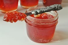 a spoon full of jam on top of a table