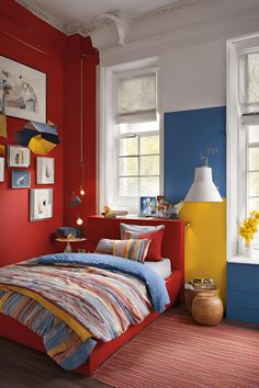 a bed room with a neatly made bed and colorful walls