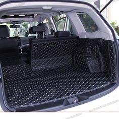 the back end of a white car with its cargo compartment open and luggage in it