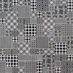 a black and white patchwork rug with squares, circles, and crosses on it