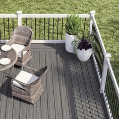 a deck with wicker furniture and potted plants on the top floor, next to a white railing